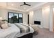 Serene bedroom with a balcony, fireplace, plush chairs and tray ceilings that create a calming atmosphere at 2495 Red Hawk Pl, Broomfield, CO 80023