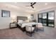 Bright bedroom with balcony access, elegant furniture, and scenic views from large windows at 2495 Red Hawk Pl, Broomfield, CO 80023