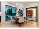 Modern dining area with wood table, modern lighting, and access to an outdoor patio space at 2495 Red Hawk Pl, Broomfield, CO 80023