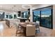 Open dining area with hardwood floors, modern lighting, and access to the modern kitchen and outdoor views at 2495 Red Hawk Pl, Broomfield, CO 80023