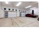 Spacious garage with multiple car spaces, electric vehicle, and ample storage at 2495 Red Hawk Pl, Broomfield, CO 80023