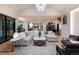 Open-concept living room with hardwood floors, plush seating, and modern decor, perfect for relaxing or entertaining guests at 2495 Red Hawk Pl, Broomfield, CO 80023