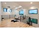 Stylish loft area with hardwood floors, modern railing, contemporary lighting, and expansive windows at 2495 Red Hawk Pl, Broomfield, CO 80023