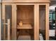 Home sauna with wooden interior, glass door, wooden bucket, and shelves for ultimate relaxation at 2495 Red Hawk Pl, Broomfield, CO 80023