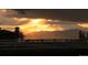 Picturesque sunset view with mountain silhouettes, white fence, and dramatic sky at 2495 Red Hawk Pl, Broomfield, CO 80023