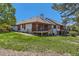Backyard shows spacious lawn, exterior of the home, and dual decks at 6663 S Prescott Way, Littleton, CO 80120