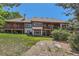 Wide backyard shows lawn, tile roof, exterior of the home, and tiered patios at 6663 S Prescott Way, Littleton, CO 80120