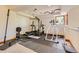 Basement features a home gym with weightlifting equipment and ample space at 6663 S Prescott Way, Littleton, CO 80120