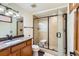 Bathroom features a glass shower, granite countertop, and modern fixtures at 6663 S Prescott Way, Littleton, CO 80120