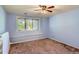 Simple bedroom with a view of the trees outside the window and a purple carpet at 6663 S Prescott Way, Littleton, CO 80120