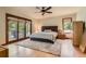 Comfortable bedroom with a ceiling fan, rug, and sliding doors leading to a patio at 6663 S Prescott Way, Littleton, CO 80120