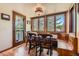 Cozy dining area featuring wood accents, natural light, an ornate light fixture, and an outdoor view at 6663 S Prescott Way, Littleton, CO 80120