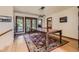 Bright dining room with hardwood floors, an ornate rug, a rustic table, and outdoor access through french doors at 6663 S Prescott Way, Littleton, CO 80120