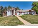 Charming single-story home boasting a well-manicured lawn, lovely desert landscaping, and a neutral color palette at 6663 S Prescott Way, Littleton, CO 80120