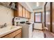 Bright laundry room features a modern washer and dryer, sink, and plenty of storage at 6663 S Prescott Way, Littleton, CO 80120