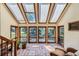 Bright sunroom with skylights, tile flooring, and many windows with backyard views at 6663 S Prescott Way, Littleton, CO 80120
