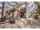 Backyard view with a wooden deck, outdoor seating, and mature trees at 1579 W Briarwood Ave, Littleton, CO 80120
