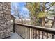 Private balcony with stone accents, railing and views of mature landscaping at 1579 W Briarwood Ave, Littleton, CO 80120