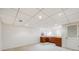 Finished basement with neutral carpet, a wet bar, and clean white walls at 1579 W Briarwood Ave, Littleton, CO 80120