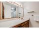 Bathroom featuring single sink vanity with large mirror and open shelving at 1579 W Briarwood Ave, Littleton, CO 80120