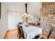 Inviting dining room featuring hardwood floors, modern lighting, and natural light at 1579 W Briarwood Ave, Littleton, CO 80120