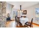 Inviting dining room featuring hardwood floors, modern lighting, and natural light at 1579 W Briarwood Ave, Littleton, CO 80120