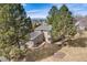 Exterior elevation of a two-story home with stone accents and mature trees at 1579 W Briarwood Ave, Littleton, CO 80120