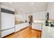 Bright, spacious kitchen with white cabinets, stainless steel appliances, and convenient access to the rest of the home at 1579 W Briarwood Ave, Littleton, CO 80120