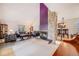 Bright and airy living room featuring a stone fireplace and vaulted ceiling at 1579 W Briarwood Ave, Littleton, CO 80120
