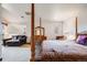 Spacious primary bedroom with four-poster bed, sitting area, and ample natural light at 1579 W Briarwood Ave, Littleton, CO 80120