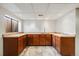 Basement wet bar boasts ample counter space, wood cabinets and a convenient sink at 1579 W Briarwood Ave, Littleton, CO 80120