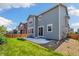 The home's backyard includes a small patio, grass, and a wooden fence surrounding the property at 10983 Uvalda St, Commerce City, CO 80022