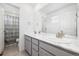 Modern bathroom with double sinks, marble countertops, and a separate toilet area at 10983 Uvalda St, Commerce City, CO 80022