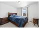 Inviting bedroom with a comfortable bed, wooden furniture, and window with natural light at 10983 Uvalda St, Commerce City, CO 80022