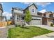 Beautiful two-story home with a manicured lawn, gray siding, and a welcoming front porch at 10983 Uvalda St, Commerce City, CO 80022