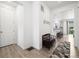Bright and inviting foyer with hardwood floors and view of the kitchen at 10983 Uvalda St, Commerce City, CO 80022