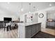 Open-concept kitchen with granite island and adjacent dining area at 10983 Uvalda St, Commerce City, CO 80022