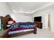 Cozy main bedroom featuring a classic wood bed frame and ample natural light at 10983 Uvalda St, Commerce City, CO 80022