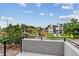 Scenic view from the balcony showcasing neighborhood homes and lush greenery under a bright sky at 3908 Mariposa St, Denver, CO 80211