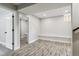 Spacious basement with wood-look floors, recessed lighting, and open doorway at 3908 Mariposa St, Denver, CO 80211