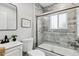 Stylish bathroom featuring marble tile, a modern vanity, and a glass-enclosed shower at 3908 Mariposa St, Denver, CO 80211