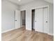 Bedroom with wood floors, neutral paint, open closet and two doorways at 3908 Mariposa St, Denver, CO 80211