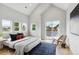 Bright, spacious bedroom with vaulted ceilings, natural light, and access to a balcony at 3908 Mariposa St, Denver, CO 80211