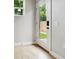 Sunlit entryway featuring a glass panel door with a digital lock and wood-look flooring at 3908 Mariposa St, Denver, CO 80211