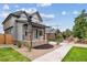 New home with a covered porch featuring stone accents and meticulous landscaping at 3908 Mariposa St, Denver, CO 80211