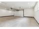 Spacious three car garage with concrete flooring, recessed lights, and an automatic garage door at 3908 Mariposa St, Denver, CO 80211