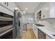 Well-equipped kitchen with stainless steel appliances, white cabinets, and modern finishes at 3908 Mariposa St, Denver, CO 80211