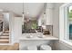 Modern kitchen with white cabinets, stone countertops, pendant lighting, and breakfast bar at 3908 Mariposa St, Denver, CO 80211
