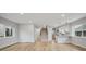Spacious open-concept living space with hardwood floors leading to the kitchen and staircase at 3908 Mariposa St, Denver, CO 80211
