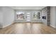 Sunlit living area featuring hardwood floors, large windows, and a modern fireplace at 3908 Mariposa St, Denver, CO 80211